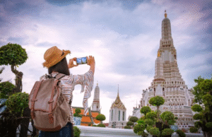 Affordable World traveler taking a photo at a temple in Thailand during guided tour